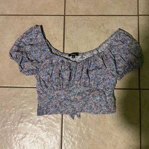 blue crop top. puff sleeves. ties up in back. US size small
